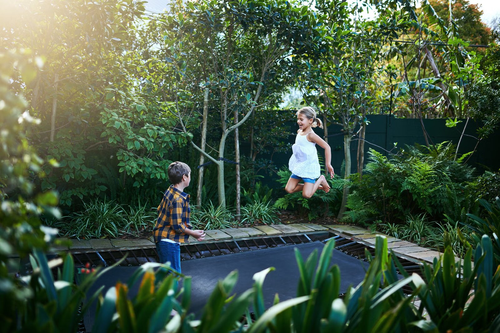 It’s important to think about how play areas can be woven into the space. Sunken trampolines are great option