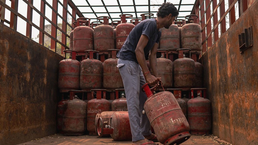 A worker loads LPG cylinders onto a truck near a gas depot in New Delhi, India.