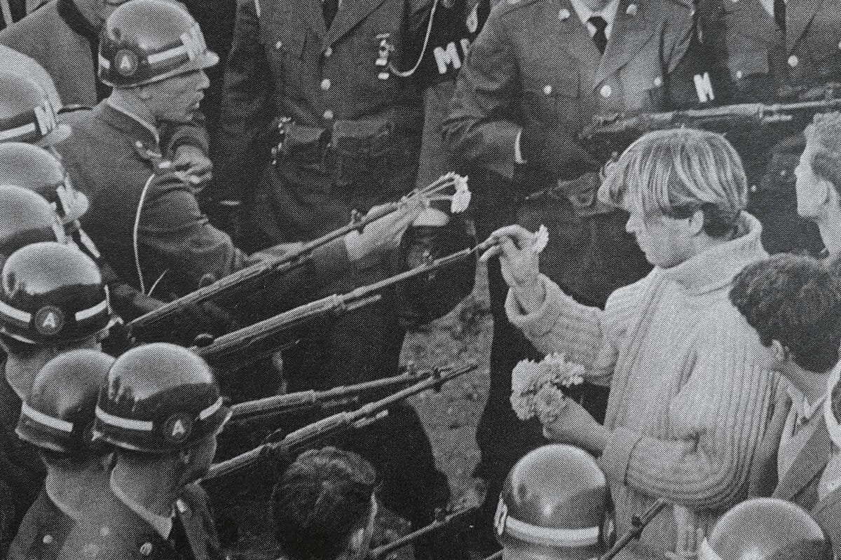 "Flower Power" was taken by Bernie Boston The Washington Evening Star on October 21, 1967, during the March on the Pentagon by the National Mobilization Committee to End the War in Vietnam. It shows a protester placing a carnation into the barrel of an M14 rifle held by a soldier of the 503rd Military Police Battalion (Airborne).