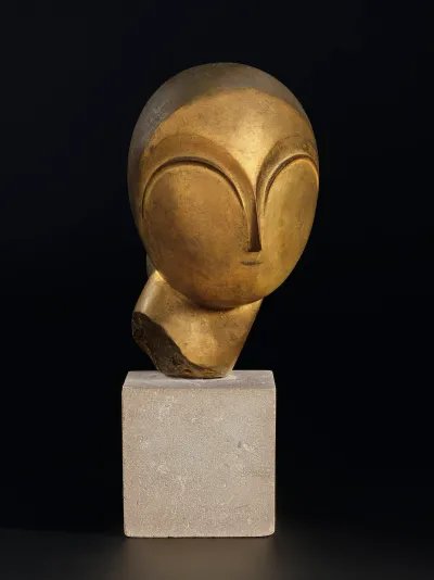 A sculpture of an abstracted head on a pedestal.
