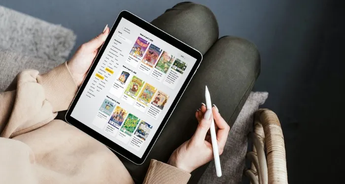 someone looking at the New Release Index children's books on a tablet