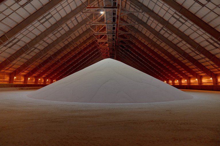 Fertilizer is stored as a large pile in a warehouse in Iowa