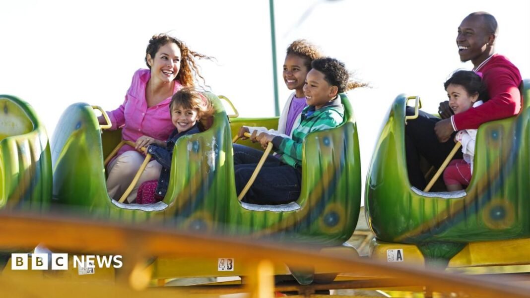 Cheaper theme park tickets and kids' meals as VAT cut A stock image of a family enjoying a rollercoaster.