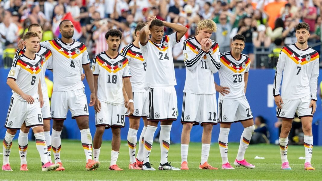 Germany players react after being knocked out of the World Cup by Paraguay