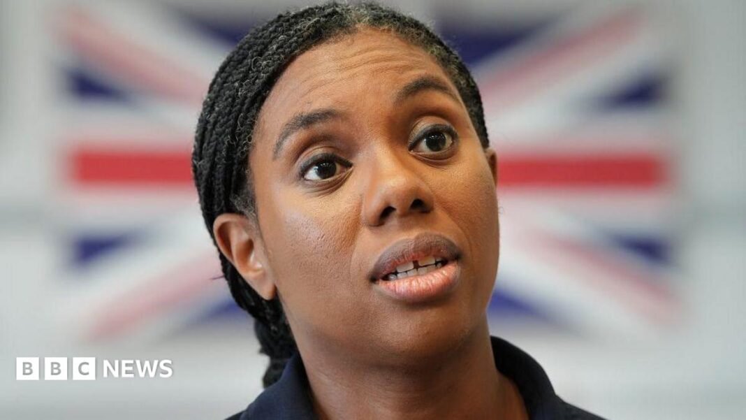 Burnham is 'people pleaser' with 'airy fairy' plans, says Kemi Kemi Badenoch speaking, with a blurred Union Jack in the background