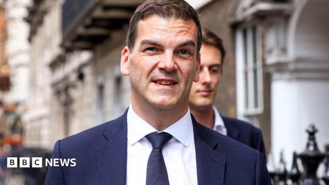 Olly Robbins pictured in a dark suit leaving the Cabinet Office on Whitehall 