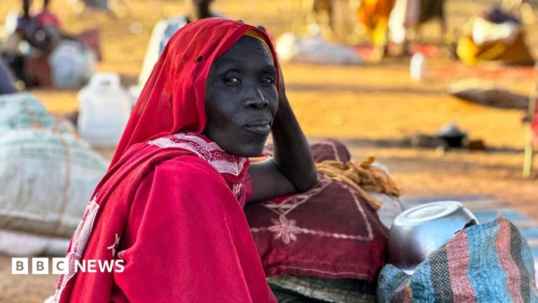 International court tells BBC of breakthrough in Sudan war crimes A woman wearing a red outfit and headscarf gazes past the camera