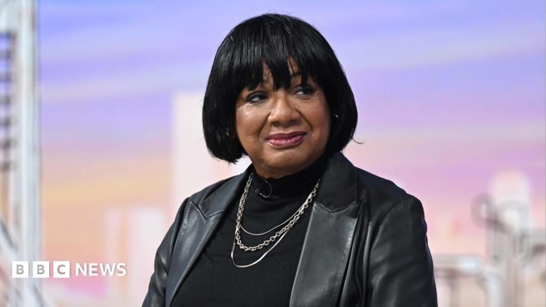 Diane Abbott sitting in the Sunday with Laura Kuenssberg TV studio, wearing a black leather jacket over a black top