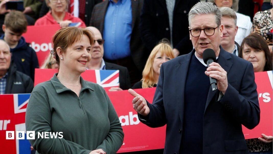 Claire Ward stood next to Keir Starmer on a campaign visit infront of labour party signs
