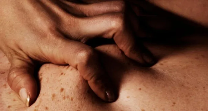 a cropped cover of Perverts, featuring a closeup of hand gripping skin