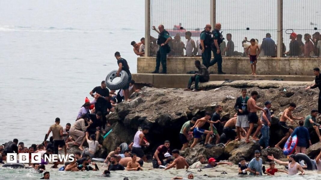 panish military stands guard at the border between the Spanish enclave of Ceuta and Morocco
