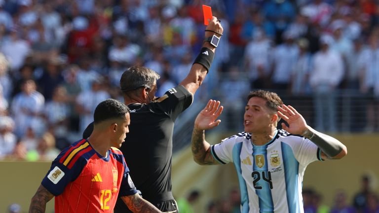 Referee Slavko Vincic, of Slovenia, gives a red card to Argentina's Enzo Fernandez (24) as Spain's Pedro Porro (12) looks on during the World Cup final soccer match between Spain and Argentina in East Rutherford, N.J., near New York, Sunday, July 19, 2026. (AP Photo/Pamela Smith)