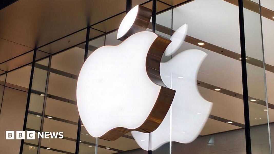 Apple issues new challenge against UK order for access to Apple logo lit up on a sign on the glass windows of a storefront in China.