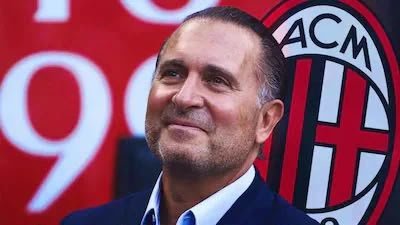 Smiling man in front of AC Milan logo